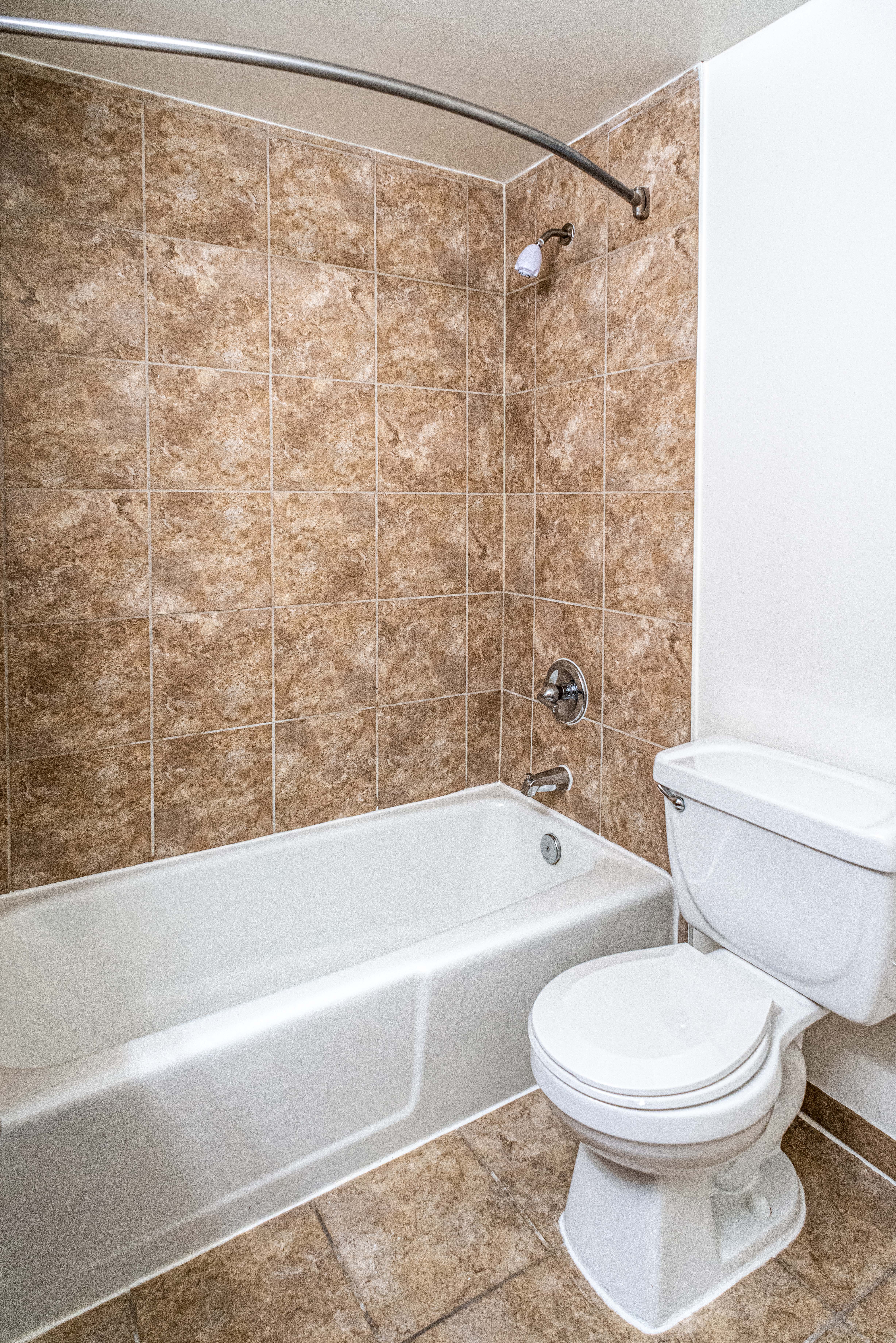 Updated bathrooms with tiled bathroom shower and tub, cherry maple vanity and premier lighting
